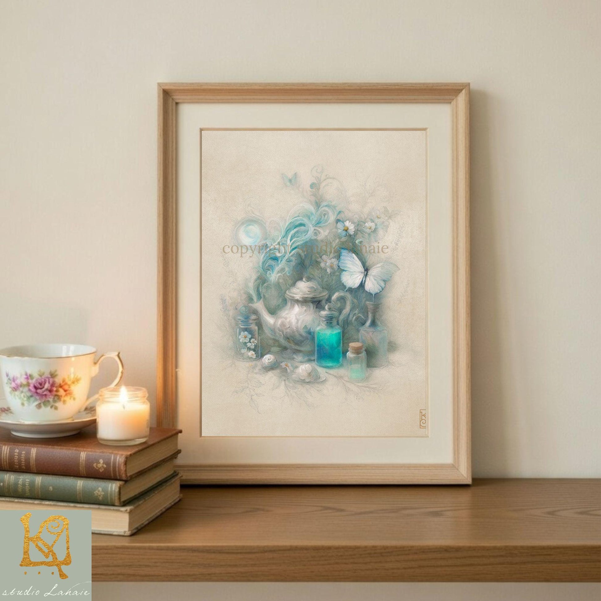a framed artwork depicting a teapot, flowers, and butterflies, placed on a wooden shelf next to a stack of books and a lit candle.