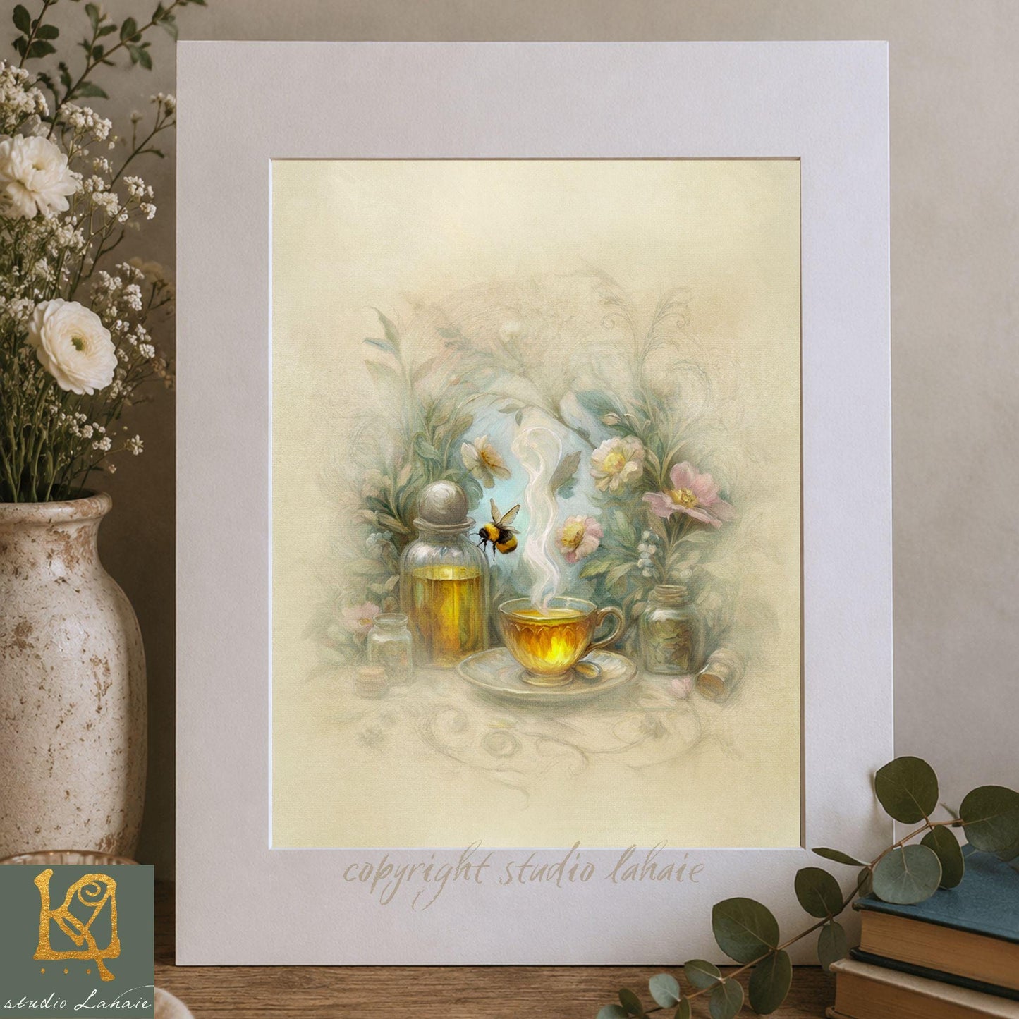 A framed print depicting a tea set with a steaming cup of tea, surrounded by flowers and a bee, placed on a wooden surface.