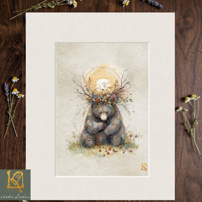 A framed illustration of a bear wearing a crown of flowers and leaves, sitting on a grassy field with a sun-like symbol above it.