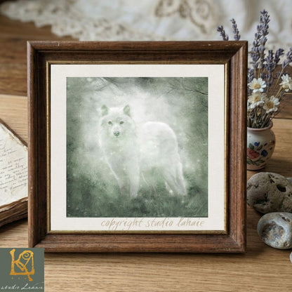 A framed painting of a white wolf standing in a forest, with a vase of flowers and a book on a wooden surface in the background.